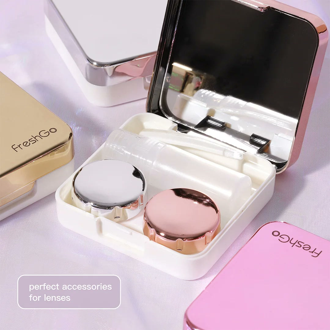 Close-up of the open FreshGo case with the mirror, lens case, tweezers and bottle